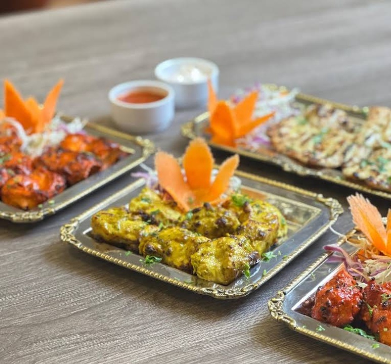 Tandoori kebabs with mint chutney and fresh garnishes